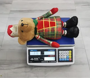 Weight measurement of a Christmas plush teddy bear soldier doll in festive plaid costume