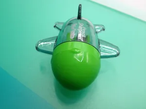 Top view of airplane-shaped pencil sharpener in bright green with translucent parts