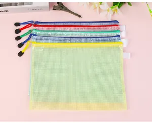Five assorted colors of mesh file bags with zipper pull cords on pink aesthetic desk