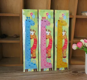 Macro detail of three colorful 15cm giraffe rulers with dual-use wavy edges in packaging
