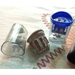 Internal view of a dual-hole pencil sharpener showing the blade and dust collector