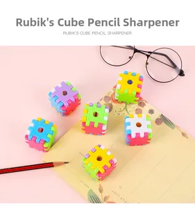 Macro detail of colorful modular cube pencil sharpeners on a pink desk background