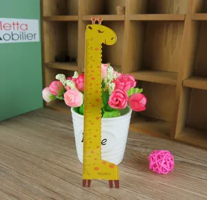 Close-up of 15cm yellow giraffe plastic ruler with wave edge on a wooden desk