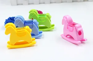 Macro shot of colorful horse-shaped pencil sharpeners with transparent waste bins