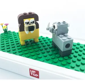 Detailed macro view of lion and rhino building blocks on a green baseplate