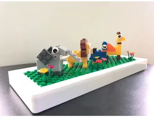 Detail of creative DIY animal building blocks on a green baseplate for students
