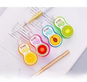 Macro shot of fruit patterned correction tapes 5mm x 5m on a book with golden pens