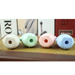 Macro view showing the bottom detail of cute cartoon cow pencil sharpeners in macaron colors
