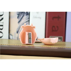 Internal structure of the pink cow pencil sharpener showing blade and waste tray