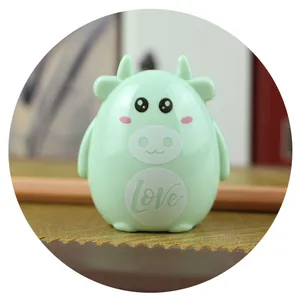 Close-up of mint green cartoon cow pencil sharpener with smooth finish and Love text