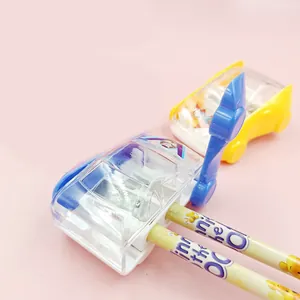 Detail of creative car pencil sharpener with manual crank and transparent waste bin