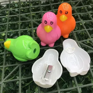 Set of three colorful penguin-shaped pencil sharpeners in pink, orange, and green colors