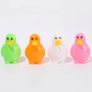 Row of four colorful penguin-shaped pencil sharpeners in green, orange, white and pink