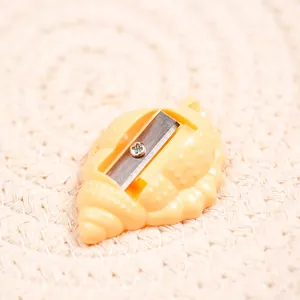 Shell shaped pencil sharpener with compact yellow design for students and office use
