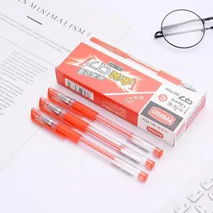 Stylos gel rouges 0,5 mm avec corps transparent et accessoires de bureau sur table