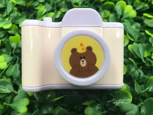 Detail of camera-shaped pencil sharpener featuring a cartoon bear and light purple buttons