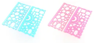 Detail view of pink and blue geometric drawing templates with hollowed patterns