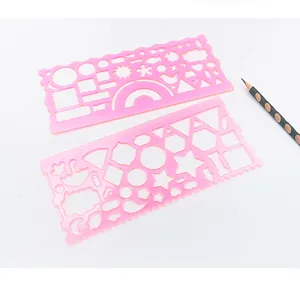 Detail of pink plastic geometric drawing templates with scales and stencils for kids