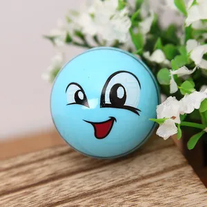 Close-up of a blue cartoon football sharpener with a smiley face on a wooden desk