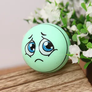 Green cartoon football pencil sharpener with sad face expression on a wooden stand