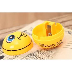 Detail view of the internal metal blade and yellow plastic shell of a smiley face sharpener