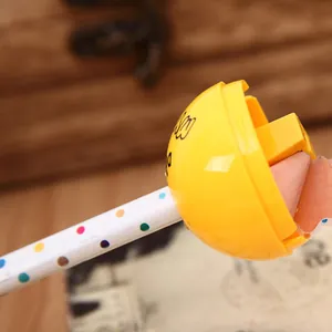 Detail macro view of a yellow ball-shaped sharpener carving a wooden pencil with ease