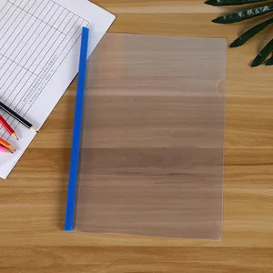Detail view of blue sliding bar folder on wooden desk with translucent A4 cover