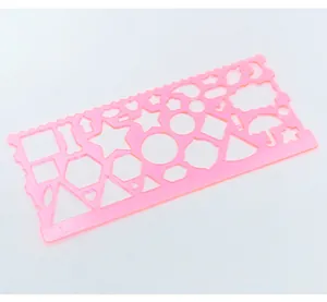 Pink translucent geometric drawing template ruler with various shapes for kids