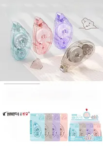 Detail view of cartoon double-sided glue tape pens in four colors with cute bear patterns
