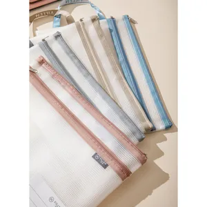 Detail of multi-colored A4 mesh document bags with zippers and portable handle straps