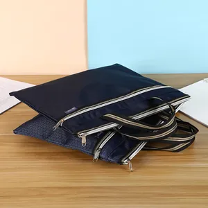 Detail view of deep blue oxford fabric file bag with triple zippers and reinforced handles