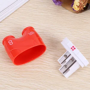Dual-hole manual pencil sharpener in red plastic with white internal cutting components