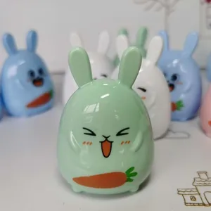 Close-up of mint green cute rabbit pencil sharpener with carrot detail for kids