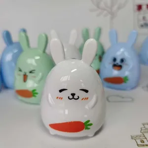 Macro detail of cute white rabbit pencil sharpener with orange carrot design and ears