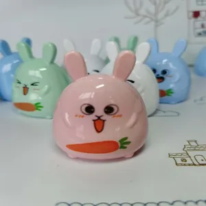 Close-up of cute rabbit pencil sharpeners in pink, blue and green with carrot detail