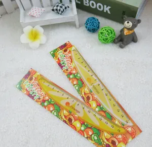 Detail of 15cm lemon and orange fruit rulers with creative floral patterns on white lace