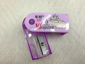 Detailed top view of purple plastic pencil sharpener with internal blade on white fabric