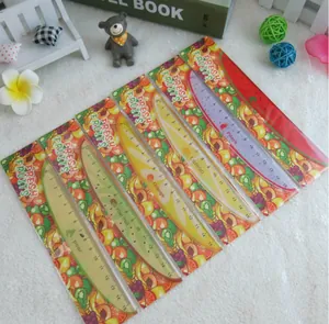 Detailed macro shot of 15cm fruit-themed plastic rulers with colorful fruit backing cards