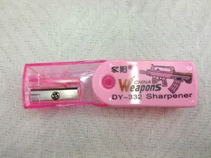 Detail view of pink transparent sharpener with metal blade and gun pattern print