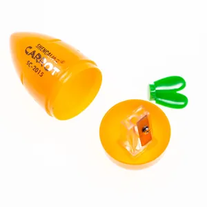 Macro view of carrot-shaped pencil sharpener showing detachable parts and internal metal blade