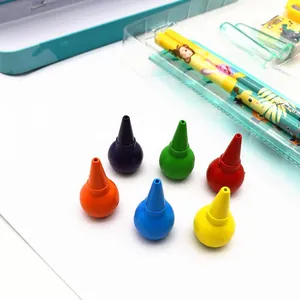 Close-up of colorful round-grip crayons and cartoon animal stationery set for kids