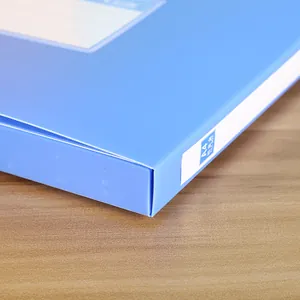 Macro detail of blue A4 PP file box with focus on labeling area and matte plastic texture