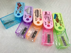Set of five colorful mini manual pencil sharpeners with military theme icons on top