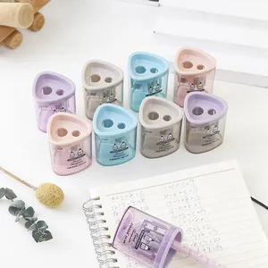Detailed macro view of Morandi-colored dual-hole pencil sharpeners on a desk