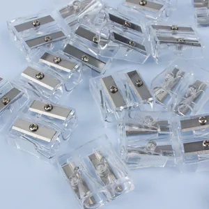 Detailed view of clear dual-hole pencil sharpener with steel blades on blue background
