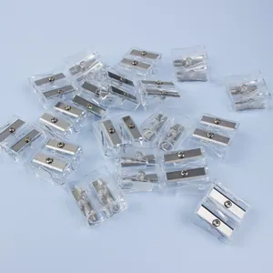 Transparent dual-hole pencil sharpener with metal blades on a light blue background