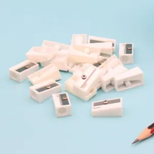 Group of white single-hole pencil sharpeners with steel blades on blue background