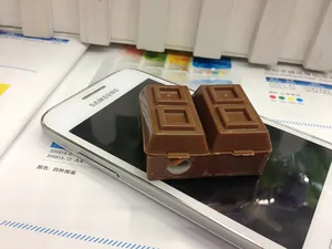 Detailed view of chocolate-shaped pencil sharpener placed on a desk with colorful brochures