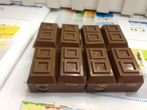 Macro shot of realistic chocolate bar shaped pencil sharpener with grid texture details