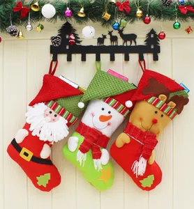 Vue détaillée de chaussettes de Noël en peluche avec motifs Père Noël, bonhomme et renne